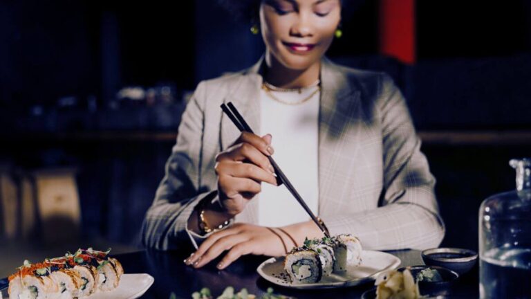 woman eating sushi in a restaurant and being able to leave a review